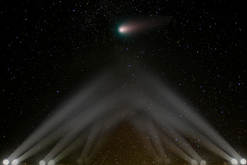 Comet asteroid flies towards the earth, illuminated by spotlights. The elements of this image furnished by NASA.

/urls:
https://solarsystem.nasa.gov/resources/429/perseids-meteor-2016/ 
https://solarsystem.nasa.gov/resources/519/ison-in-november-by-hubble/
https://images.nasa.gov/details-NHQ201809150005.html