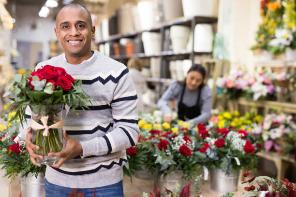 istock Male customer chooses flowers in shop 1299712880