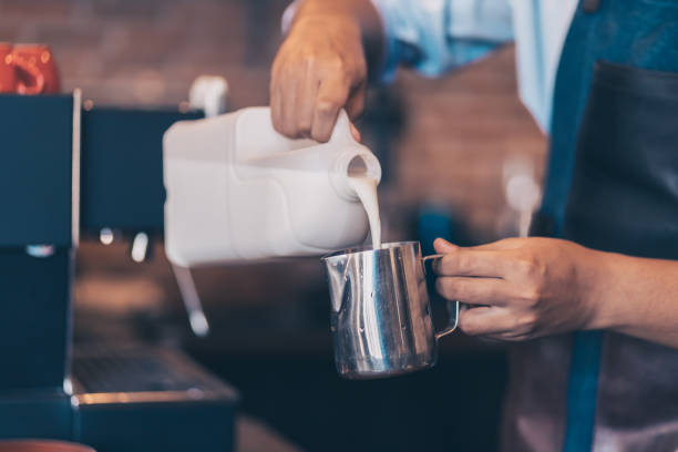 istock Barista making cappuccino, bartender prepare coffee drink at coffee shop . 1299713949