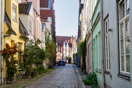 Beautiful cozy courtyard with old houses and flowers in the street of old town Lubeck, Germany