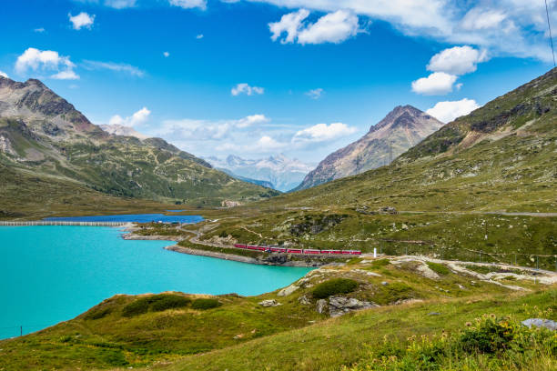 bernina express at the white lake in ospizio bernina, engadin, switzerland - bernina express imagens e fotografias de stock