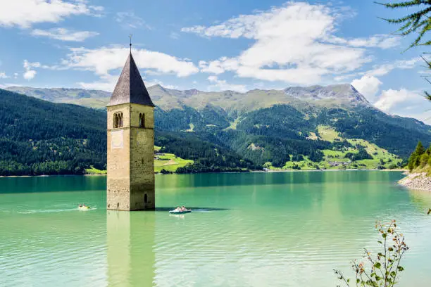 The famous bell tower in the Lake of Reschen - Lago di Resia in South Tyrol, Italy. During WW2 a dam was build and put the village under water, only the tower is still visible now.