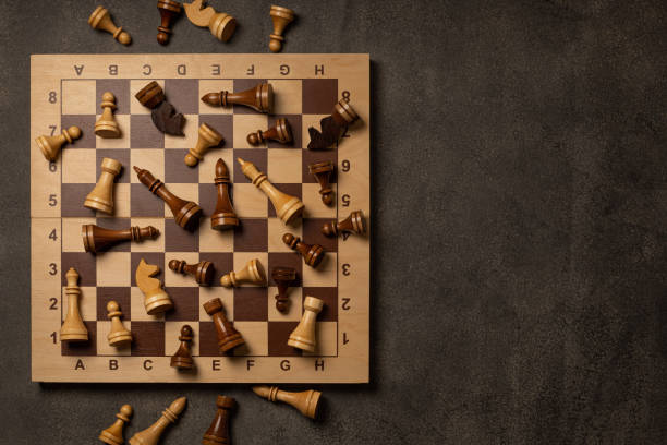 istock Chess pieces are scattered chaotically on a chessboard 1299718414
