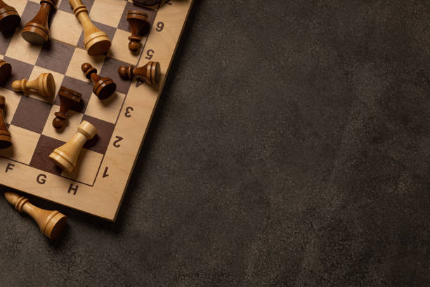 istock Chess pieces are scattered chaotically on a chessboard 1299718471