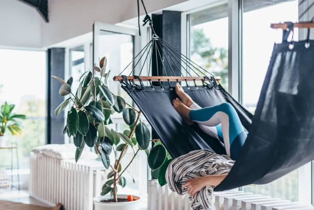 istock Woman is lying at home in a hammock and resting 1299719517