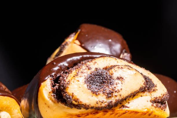 istock Rolled buns with poppy seeds, covered with chocolate icing 1299720977