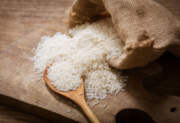 istock Raw white rice on a wooden board 1299721866