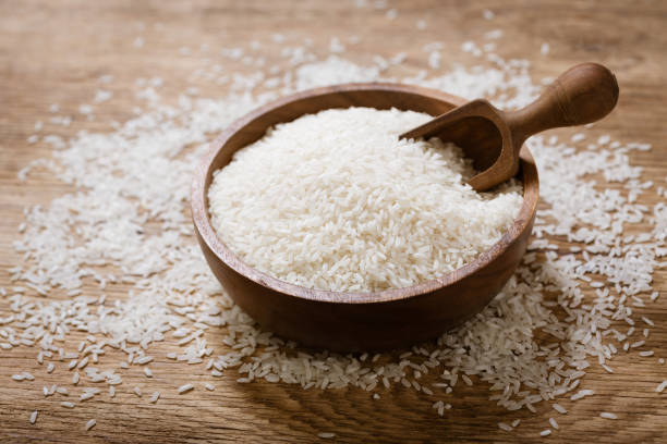 istock raw white rice on a wooden board 1299721872