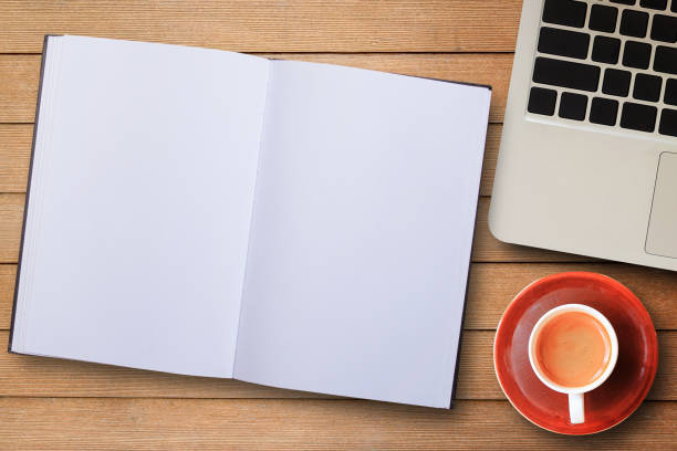 istock Laptop computer and coffee cup top view on wooden table background. 1299722213