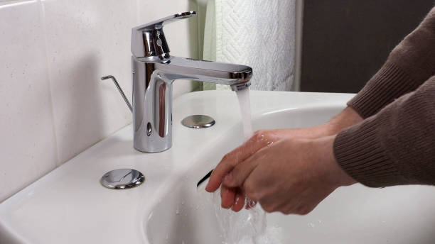 istock Unrecognisable person washing hands 1299722249
