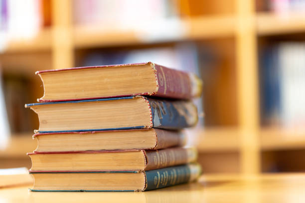 istock Books stacked on tables at the university library 1299727696