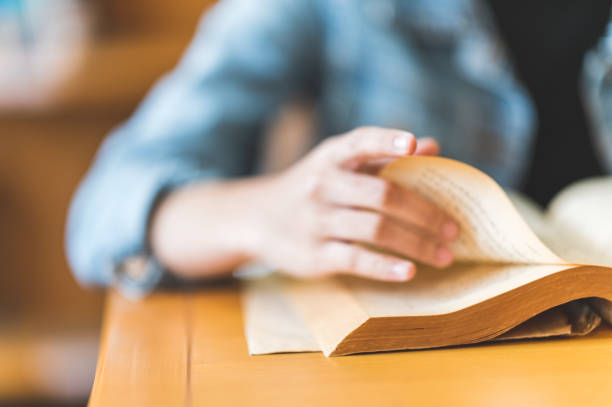 istock A female college student sitting in the university library reading 1299729020