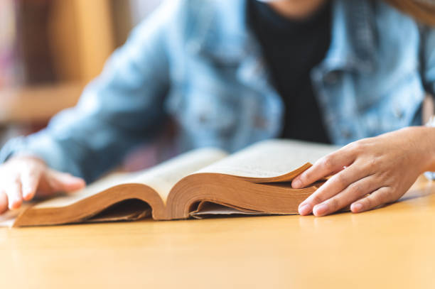 istock A female college student sitting in the university library reading 1299729056