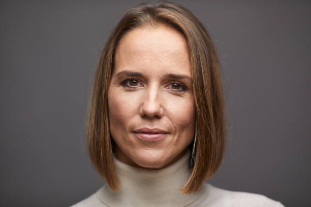 istock Adult's beautiful woman studio portrait looking at camera. 1299729269