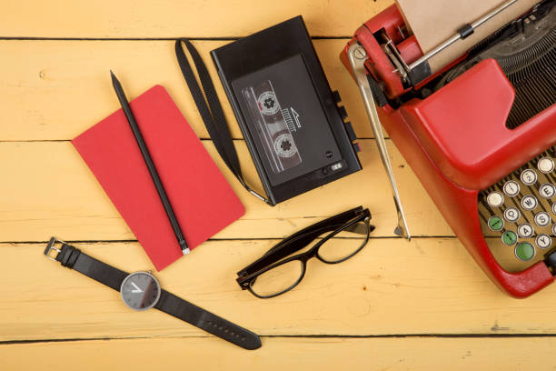 istock Journalist or private detective workplace - typewriter, recorder and other stuff on the yellow planks 1299729317