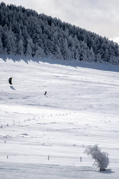 istock A man practices sonwkiting in the distance on a snow field 1299729402