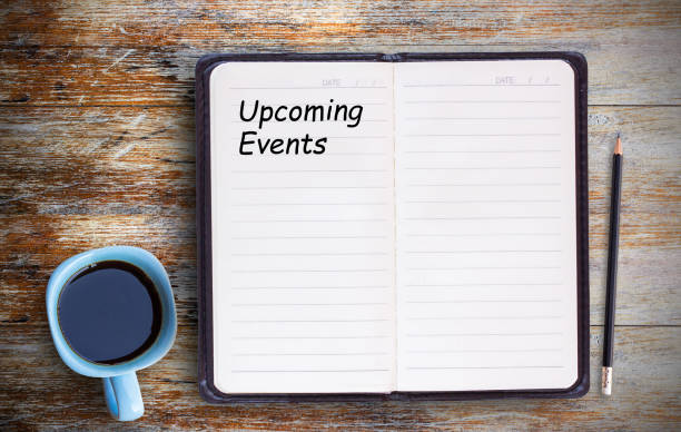 istock Text with Upcoming Events and coffee cup, notebook,pencil on grunge wooden table. 1299729555