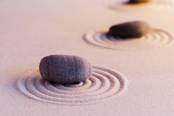 istock Zen garden stones on sand with ornament 1299730608