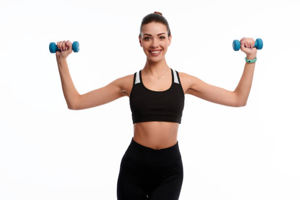 istock Attractive caucasian slim woman doing physical exercise using dumbbell isolated on white background 1299731358
