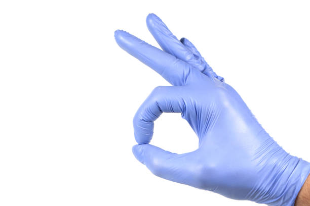 istock Hand in blue glove isolated on white showing ok sign. 1299731501