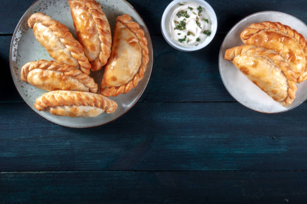 istock Empanadas with a white sauce, shot from the top with a place for text 1299731563