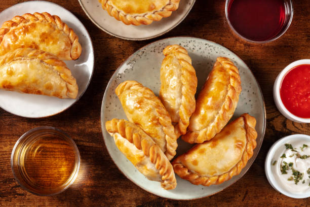 istock Many empanadas on a dark rustic wooden background 1299731583