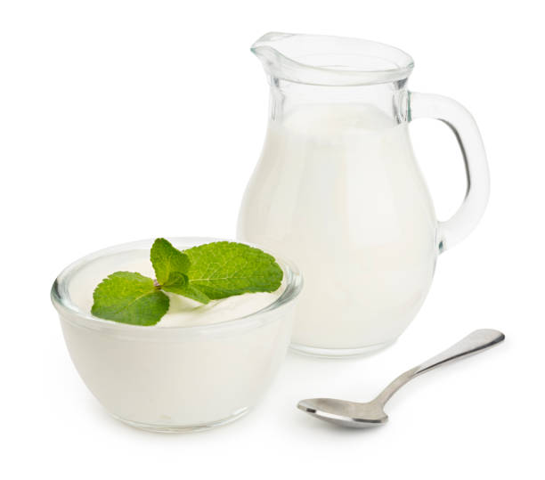 istock Yogurt with mint leaves, milk in a jar and spoon on white background 1299731811