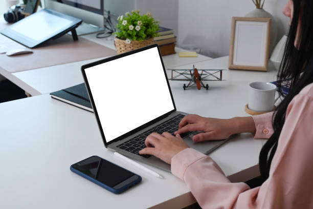 istock Side view of young woman entrepreneur working on laptop computer at modern home office. 1299732097