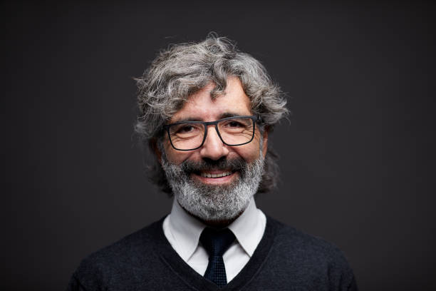 One Spanish senior man headshot portrait smiling at the camera.