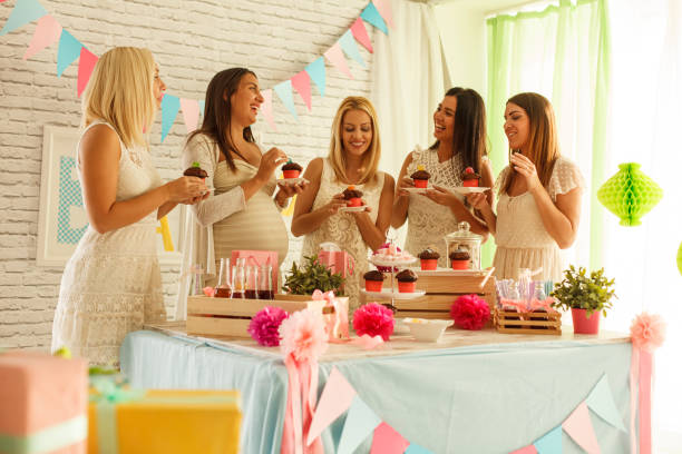 istock Girlfriends chatting and enjoying cupcakes during a baby shower 1299733122
