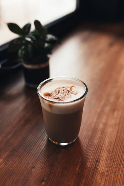 istock Cup of coffee at table in cafe near window. Blurred background 1299733351
