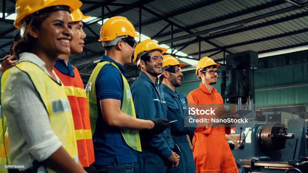 Skillful worker attending brief meeting in the factory . Skillful worker attending brief meeting in the factory . Industrial people and manufacturing labor concept . Occupation Stock Photo