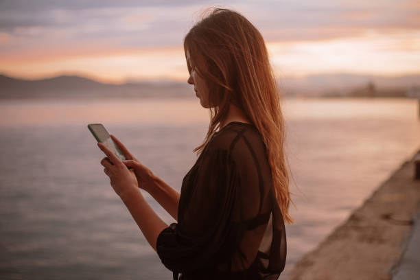 istock Young woman using a smart phone 1299734123