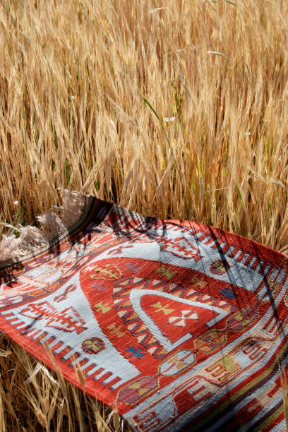 istock Wheat field and antique rug. 1299734365