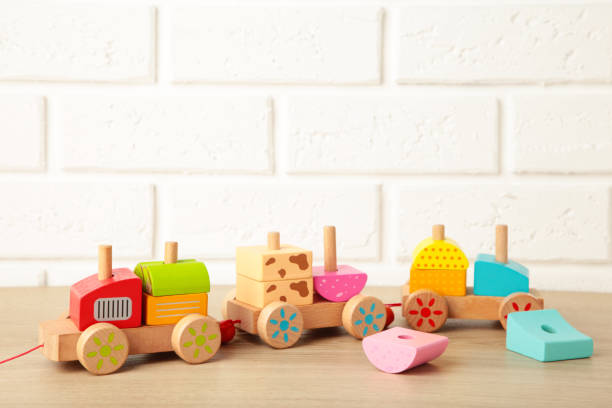 istock Stacking train toddler toy for little children on light background with shadow reflection. 1299735509