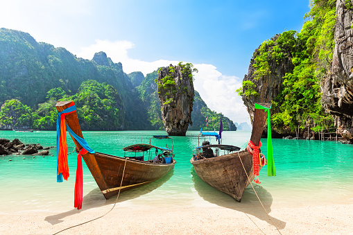 Foto de viaje de la isla de James Bond con barco de cola larga tradicional tailandesa y hermosa playa de arena en la bahía de Phang Nga, Tailandia. photo