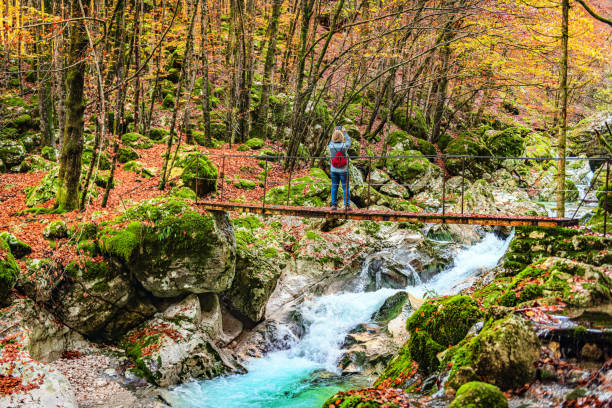 Mature female Enjoying by the river Soča, Primorska, Julian Alps, Slovenia, Europe Mature female Enjoying by the river Soča, Primorska, Julian Alps, Slovenia, Europe soca valley stock pictures, royalty-free photos & images