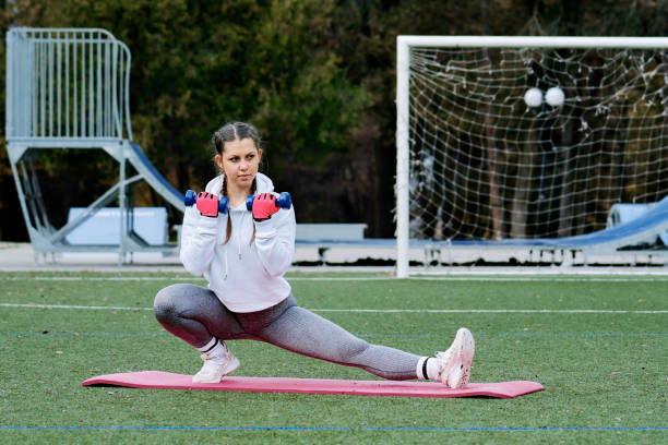 istock Active young woman exercising in park 1299738422