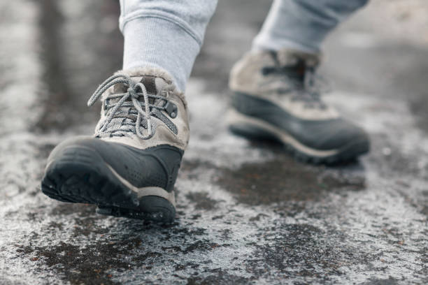 istock People slides on path. Icing on sidewalk, slippery ice-crusted ground 1299738577