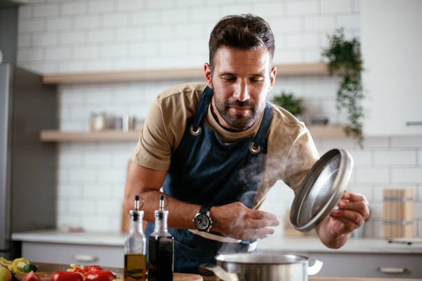 istock Young man preparing delicious food. 1299738866