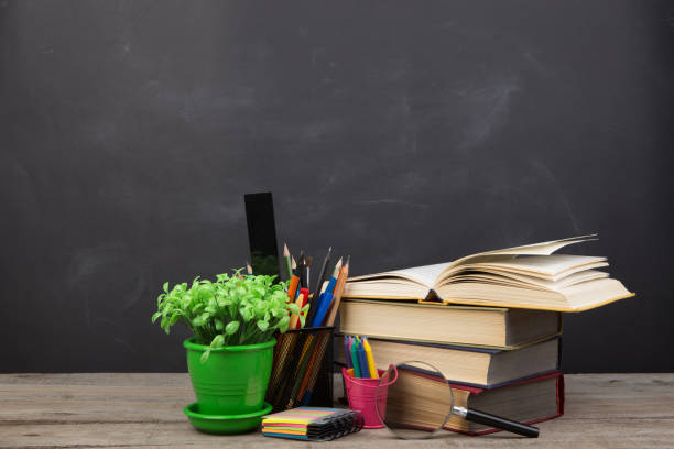 istock Education concept - books on the desk in the auditorium 1299740007