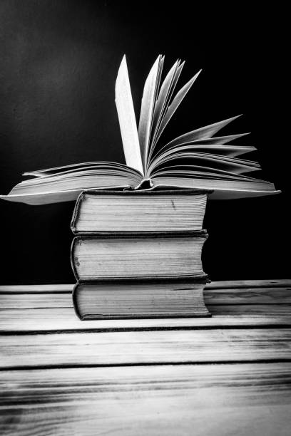 istock A stack of books on the table. At the top is an open book. World book day concept. 1299740033