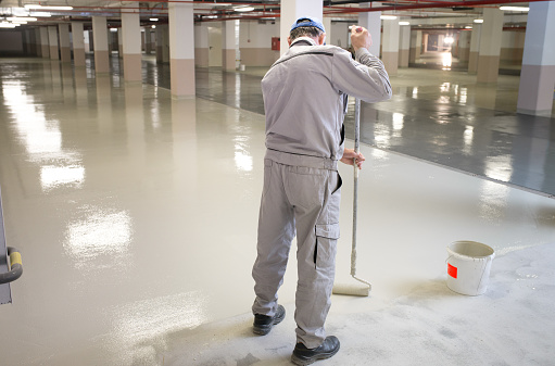 Manual worker putting non-slip layer on the floor