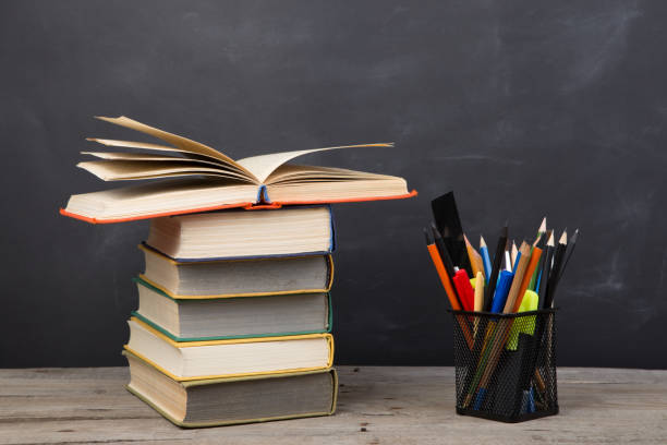 istock Education concept - books on the desk in the auditorium 1299741034