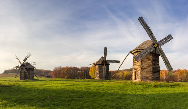 istock Old windmills standing on the lawn against the evening sky 1299741112
