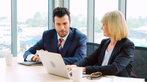 istock Two business people talk project strategy at office 1299742710