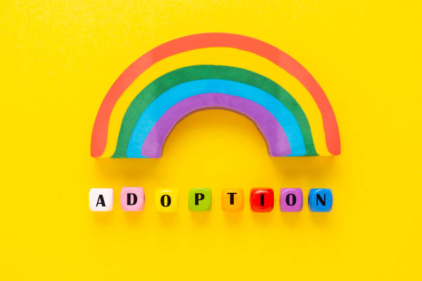 adoption word colorful yelllow background rainbow. - single word love wood typescript imagens e fotografias de stock