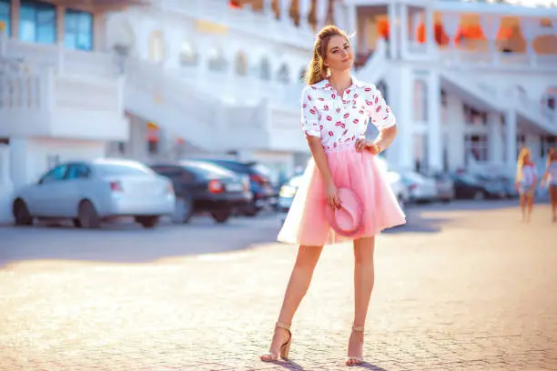 Fashion lifestyle portrait of young happy pretty woman laughing and having fun on the street at nice sunny summer day, stylish vintage outfit,bright fresh colors.