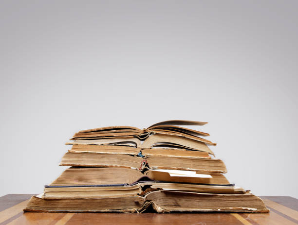 istock there are many old open books with bookmarks on a wooden table, on a gray background 1299744042