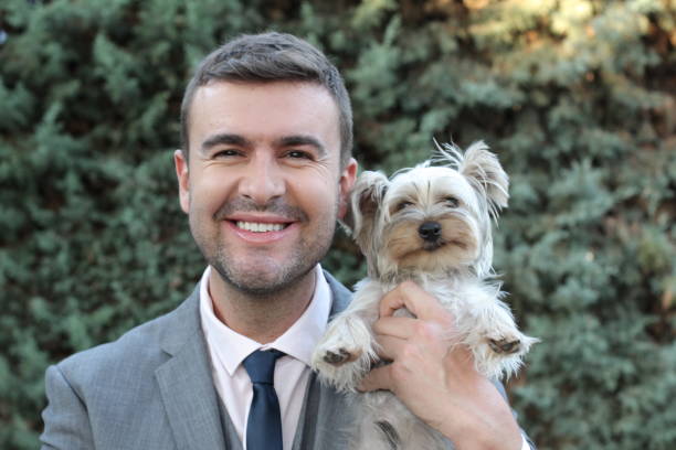 istock Stylish businessman and his Yorkshire Terrier 1299744881